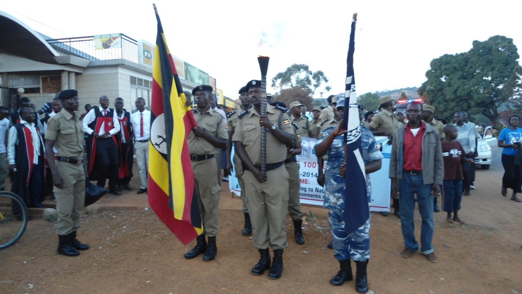 Entebbe DPC Ninsiima Godfrey reassures residents on community policing. DPC Ninsiima Godfrey holding the torch light during the celebrations to mark the centenary celebrations