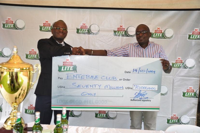 Entebbe Club chairman receives a dummy cheque worth Shs 70m from Nile Breweries Isaac Sekasi.