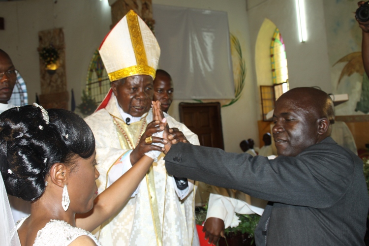 Cardinal Emeritus Wamala joins Kayanja and Nabakooza as husband and wife at Bugonga Catholic Church.