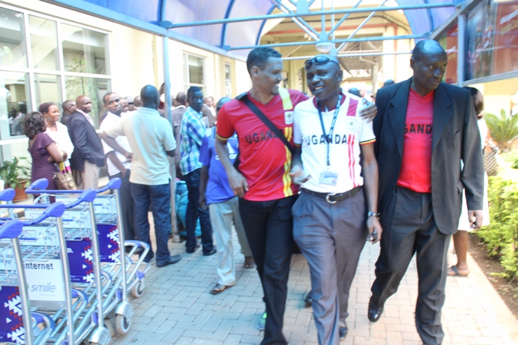 Fufa CEO Edgar Watson and Asuman Lubowa with another Fufa Official (middle) at the Airport.