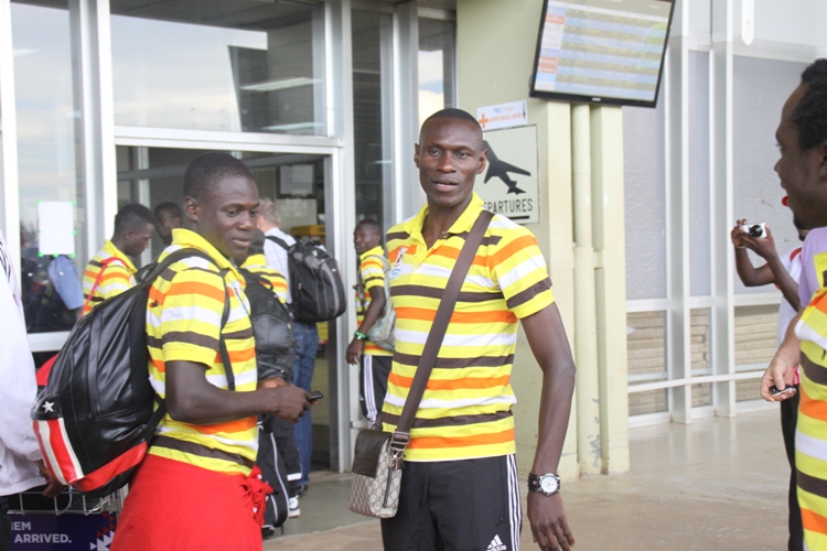 Skipper Andy Mwesigwa (centre) shares a light Moment with team mates at Entebbe Airport.