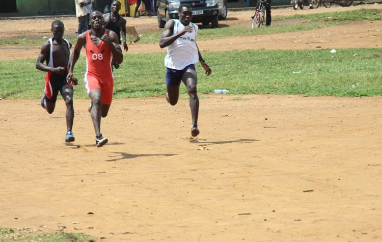 Kakaire Sam (left) runs passed Opio Joel. He won the men's 100 and 200km race.