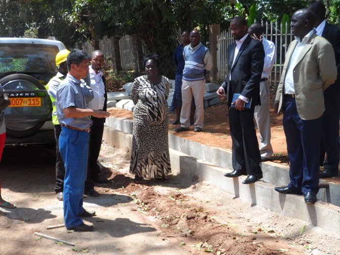 Mayor Kayanja standing right with councillors inspect Road Construction works  on church Road last week. Chinese firm Longijian Road and Bridge Construction company was contracted to undertake the projects.