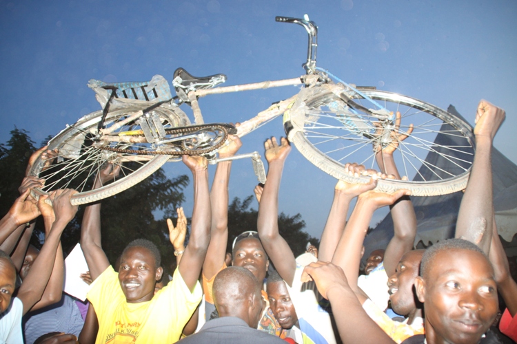Youth celebrate after receiving bicycles.