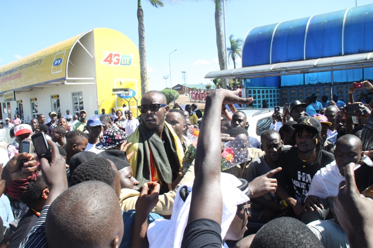 Kenzo on top of the world after arriving at Entebbe International Airport.