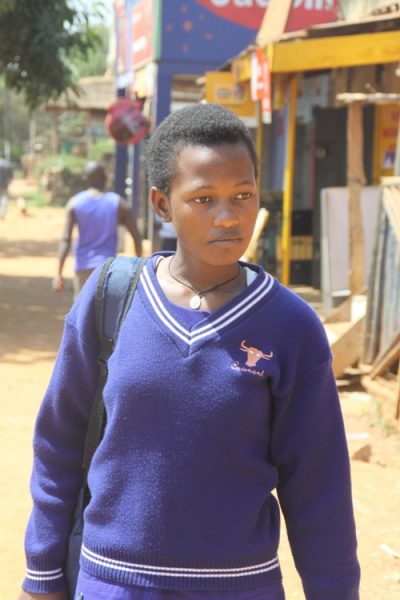 Nampala Sherinah at Mpala Police Station dressed in school uniform after being grilled by her poor Mum and police officers.