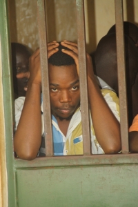 Lyto Boss looking frustrated at Entebbe Magistrate Court cells.