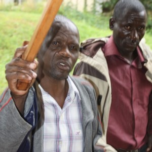 Richard Lujjaga (L) and another prisoner being led to the prison cells.