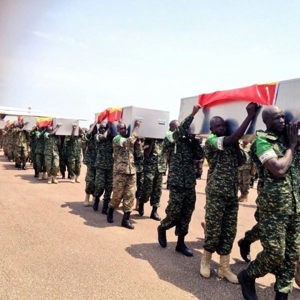 Amisom Soldiers carry caskets of the fallen colleagues at the Airforce base in Entebbe.