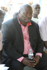 Ex Mayor Stephen Kabuye cooling off with water after surviving being knifed.