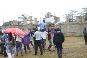 Katusabe's supporters lift him up after declared winner by EC officials.