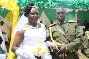 Lt. Robert Ruyondo feeling sweet with Juicy Teopista Kajumba after exchanging marriage vows.
