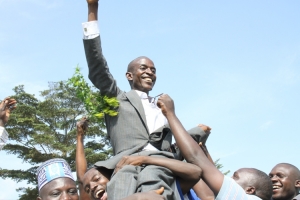 Mugabi's supporters lift him up in the air.