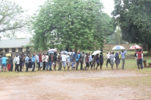 NRM youth voters line up behind Joseph Katusabe in blue shirt.