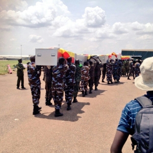 UPDF Soldiers carry the caskets of the slain Amisom Soldiers at the Airforce base in Entebbe on Thursday.