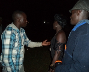 Kenneth Nyanzi  speaks to his bonk mate Winnie as plain clothed cop looks on
