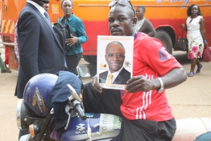 A boda boda rider with Mbabazi poster.