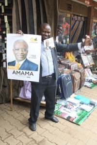 A trader in down town Kampala flashes the Go-forward symbol.