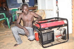 Kenneth Byamukama with the generator at Mpala Police Station.