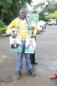 Mayor Kayanja's supporter showing off his campaign posters.