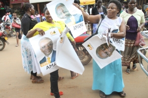 Mbabazi Supporters pose for cameras with posters.