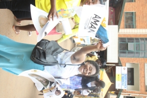 Mbabazi's women distributing campaign posters around Nakivubo stadium.