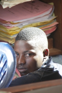 Patrick Kato hiding face from cameras.