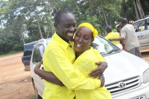 Sempala Twaha hugs Rose Tumusiime.