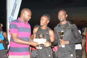 UVF boss Sadik Nasiwu hands over trophies to Emma Kato (center) and Nicholas Dhenyongera at Lido on Sunday.