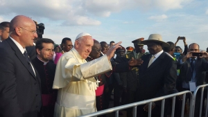 Pope Francis waves to Traditional dancers who entertained him shortly after touching down at Entebbe Old Airport. 