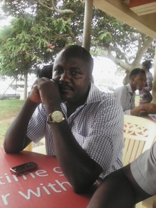 Buyinza Ephraim relaxing in bar. 