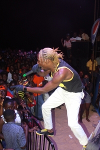 Coco Finger parading fake dreads on stage.