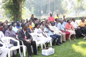 Market vendors listening attentively to Tumukunde's message.