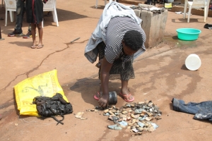 Betty Nabukeera displaying the shs14.8m notes that were burnt.