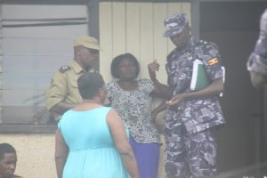 Martha Basanda (2nd from left) in pain. Nabutoono and Onyango (right) intervening in the matter.