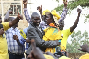 Mugerwa Abbas hugs flag bearer Rose Tumusiime.