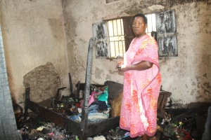 Nabukeera's business partner and relative Nanyonjo Robinah inside the bedroom where everything was burnt to ashes.