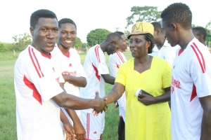 Rose Tumusiime inspecting football teams.