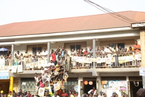 Supporters observing from a storied building.