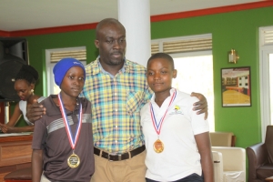 UGU Secretary Bernard Mbayo (middle) poses for a photo with winners Tom Billa (L) and Joan Napewo (R). 