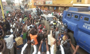 Besigye is mobbed by hundreds of his supporters in the city.