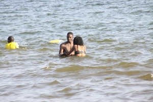 Couple squeezing tight in lake.