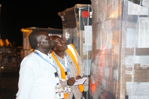 FRONASA observers Matovu Vianney Ngoma (in jacket) and Herbert Ddungu witness the arrival of the ballots.