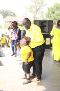 Mayoral Candidate Joseph Ssesanga massaging Sarah Short's head.