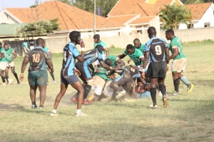 Mongers (in blue striped Jersey) take on Heathens at the Entebbe S.S Grounds.