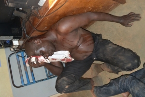 Moses Asenga bleeding like chicken at Entebbe Police Station.