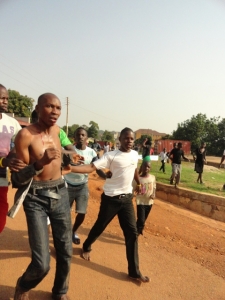 Yasin Mugisha being frog-marched to police.