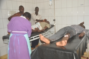 A nurse attends to James Sewakambo (L) and Ronald Bbosa (R) who were shot during the mayoral polls.