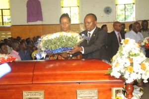 Dep. Governor Bank of Uganda Louis Kasekende and wife lay a wreath on Late Chris Kassami's casket.