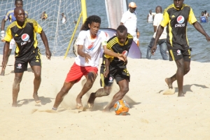 Real Galacticals' John Revita (in Red and white) dribbles past Stormers players.